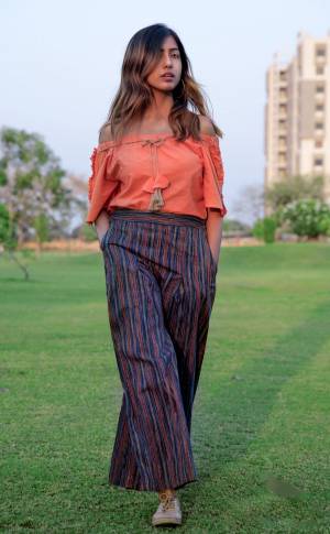 Grab This Beautiful Khadi Pair In Orange Colored Off Shoulder Top Paired With Blue Colored Pants. This Readymade Pair Is Based On Khadi Cotton Fabric Ensuring Superb Comfort All Day Long.
