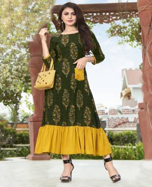 Here Is A Beautiful Designer Flair Pattern Readymade Kurti In Dark Green Color Fabricated On Rayon Beautified With Prints All Over. This Kurti Is Available In All Regular Sizes. Buy Now.