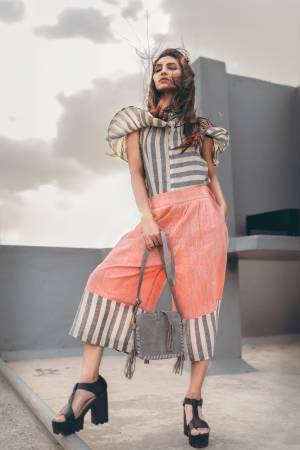 Light Orange khadi calf length pant with black and white strip pannel, it has front pockets as well as back pockets
Paired With Grey & white strip off shoulder top with frill pattern