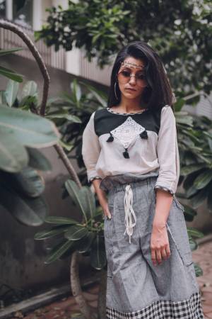 Grey khadi high waist calf length pant with full elastic at the waist 
Paired With off white top with black yoke embellished with dimond patch and teassel
sleeves - 3/4th sleeves with mid cut patern