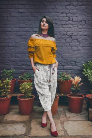 Off-White Colored khadi calf length pant with elastic at the waist and elastic at the bottom 
Paired With Musturd Yellow off shoulder top with 3/4th sleeves