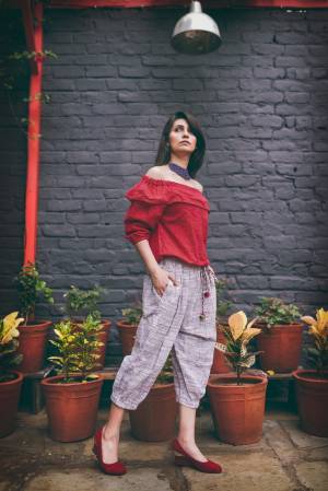 Off-White Colored khadi calf length pant with elastic at the waist and elastic at the bottom 
Paired With Red off shoulder top with 3/4th sleeves