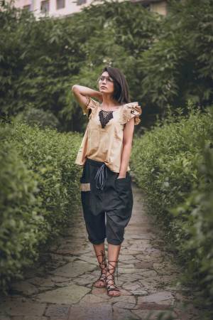 Black khadi  calf length pant with two outer pocket embellished with jute lace Paired With beige frill sleeves top with hand made tringle path lace 
