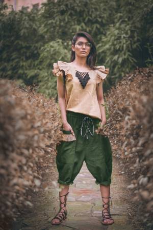 Olive Green Colored khadi  calf length pant with two outer pocket embellished with jute lace Paired With beige frill sleeves top with hand made tringle path lace 