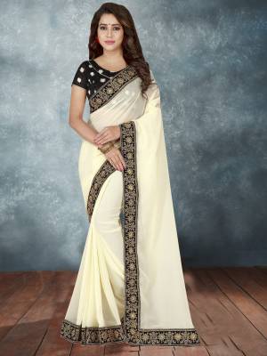 Have A Rich And Elegant Look Wearing This Designer Saree In Off-White Color Paired With Black Colored Blouse. This Saree IS Fabricated On Georgette Paired With Art Silk Fabricated Blouse.  It Has Heavy Embroidered Lace Border Over The Saree. 