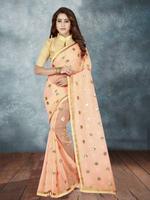 A Must Have Shade In Every Womens Wardrobe Is Here With This Designer Saree In Peach Color Paired With Beige Colored Blouse. This Saree IS fabricated On Georgette Which Is Light Weight , Paired With Art Silk fabricated Blouse. Buy This Saree Now.