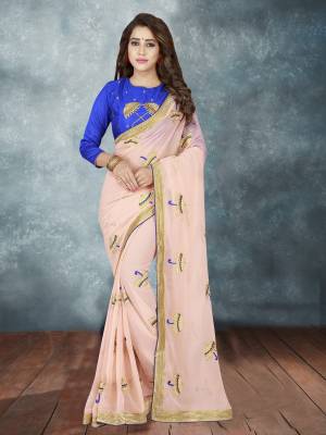 You Will Definitely Earn Lots Of Compliments Wearing This Designer Saree In Peach Color Paired With Contrasting Royal Blue Colored Blouse, This Saree Is Fabricated On Georgette Paired With Art Silk Fabricated Blouse. It Is Beautified With Umbrella Embroidered Motifs. Buy Now.