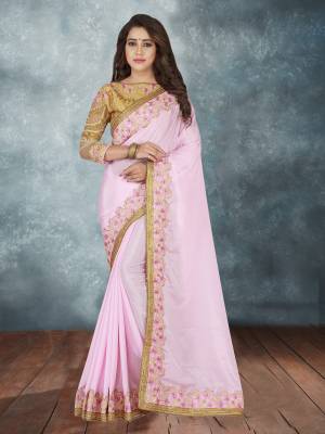 Here Is A Lovely Designer Saree In Light Pink Color Paired With Beige Colored Blouse. This Saree Is Georgette Based Paired With Art Silk fabricated Blouse. It Is Beautified With Heavy Embroidered Lace Border And Over The Blouse. 