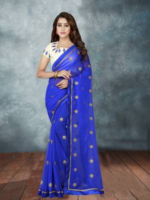 Shine Bright Wearing This Saree In Royal Blue Color Paired With White Colored Blouse, This Saree Is Fabricated On Georgette Paired With Art Silk Fabricated Blouse. It Is Beautified With Pretty Elegant Embroidery.