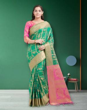 This Festive Season, Have A Proper Traditional Look Wearing This Silk Saree In Green Color Paired With Contrasting Fuschia Pink Colored Blouse. This Saree And Blouse are Fabricated On Art Silk Beautified With Weave.