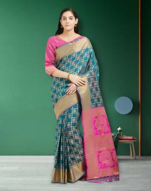Celebrate This Festive Season wEaring This Traditional Silk Saree In Blue color Paired With Fuschia Pink Colored Blouse. This Saree And Blouse are Silk Based Fabric Beautified With Weave. 