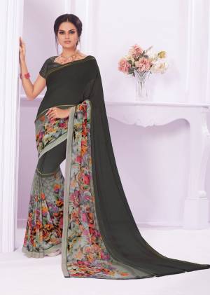 You Will Definitely Earn Lots Of Compliments Wearing This Saree In Dark Grey Color Paired With Dark Grey Colored Blouse.This Saree Is Fabricated On Georgette Paired With Crepe Fabricated Blouse. It Has Multi Colored Floral Prints Over The Saree Border.
