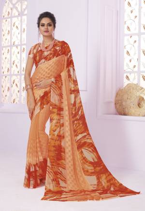 Orange Color Induces Perfect Summery Appeal To Any Outfit, So Grab This Saree In Orange Color Paired With Orange Colored Blouse. This Saree Is Georgette Paired With Crepe Blouse Beautified With Floral Prints.