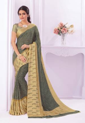 You Will Definitely Earn Lots Of Compliments Wearing This Saree In Dark Grey Color Paired With Golden Colored Blouse.This Saree Is Fabricated On Georgette Paired With Crepe Fabricated Blouse. It Has Multi Colored Floral Prints Over The Saree Border.