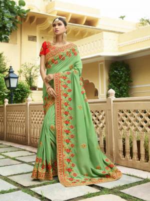 Another Pretty Traditional Combination Is Here With This Designer Saree In Light Green Color Paired With Contrasting Red Colored Blouse. This Saree Is Fabricated On Soft Silk Paired With Art Silk Fabricated Blouse. Buy This Attractive Saree Now.
