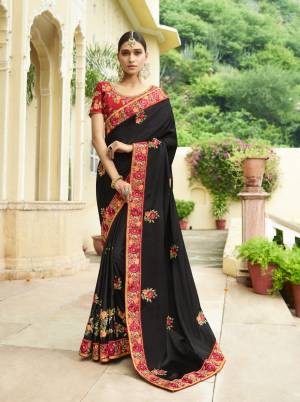 For A Bold And Beautiful Look, Grab This Designer Saree In Black Color Paired With Red Colored Blouse. This Saree And Blouse are Silk Based Fabric Beautified With Heavy Embroidery Making The Saree Attractive.