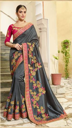 Flaunt Your Rich and Elegant Taste Wearing This Heavy Designer Saree In Dark Grey color Paired With Contrasting Dark Pink Colored Blouse. This Saree And Blouse are Silk Based Which Gives A Rich Look To Your Personality.