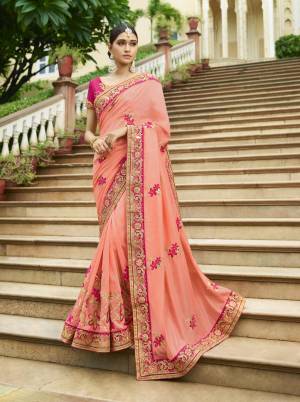 This Season Is About Subtle Shades And Pastel Play, So Grab This Pretty Designer Saree In Pastel Pink Color Paired With Contrasting Dark Pink Colored Blouse. It IS Silk Based Which Also Gives An Elegant And Rich Look.
