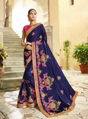 Enhance Your Personality Wearing This Designer Saree In Navy Blue Color Paired With Contrasting Dark Pink Colored Blouse. This Saree And Blouse are Silk Based Fabric Beautified With Attractive Embroidery All Over. Buy Now.