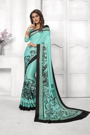 Look Attractive In This Satin Based Saree In Aqua Blue Color Paired With Aqua Blue Colored Blouse, This Saree And Blouse are Fabricated On Satin Silk Beautified With Black Colored Prints. This Saree Is Light Weight And Soft Towrds Skin And Easy To carry All Day Long. Buy Now.