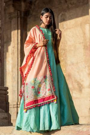 A Must Have Shade In Every Womens Wardrobe Is Here In Light Peach Color Fabricated On Khadi Cotton Beautified With Multi Colored Thread Work And Pom Pom Lace. 