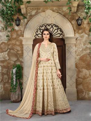 Flaunt Your Rich And Elegant Taste Wearing This Designer Floor Length Suit In Cream Color. Its Top Is Fabricated On Art Silk Paired With Santoon Bottom And Net Dupatta. It Has Heavy Jari Embroidery With Stone Work. Buy Now.