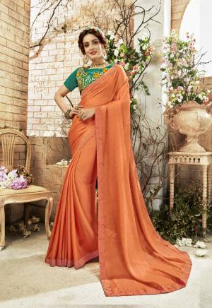 Orange Color Induces Perfect Summery Appeal To Any Outfit, So Grab This Designer Saree In Orange Color Paired With Contrasting Teal Green Colored Blouse. This Saree Is Chiffon Based Fabric Paired With Art Silk Blouse. Buy Now.