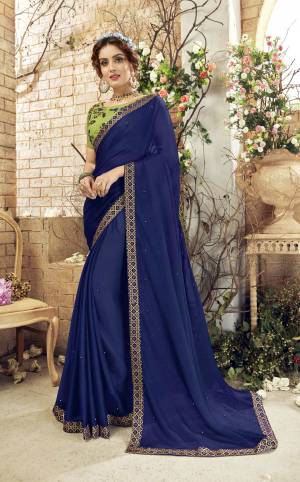 Get Ready For The Upcoming Festive And Wedding Season Wearing This Designer Saree In Dark Blue Color Paired With Contrasting Green Colored Blouse. This Saree Is Fabricated On Chiffon Paired With Art Silk Fabricated Blouse. Buy Now.
