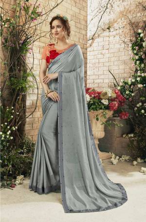 Enhance Your Personality Wearing This Designer Saree In Grey Color Paired With Contrasting Light Orange Colored Blouse. This Saree Is Fabricated On Chiffon Paired With Art Silk Fabricated Blouse. Buy Now.