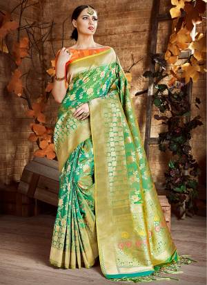 For A Proper Traditional Look, Grab This Silk Saree In Green Color Paired With Contrasting Orange Colored Blouse. This Saree And Blouse Are Fabricated On Cora Art Silk Beautified With Floral Weave. Buy Now.