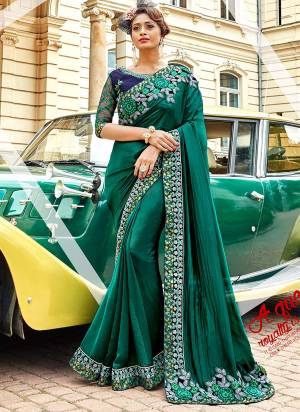 Celebrate This Festive Season Wearing This Designer Saree In Teal Green Color Paired With Contrasting Navy Blue Colored Blouse. This Saree Is Fabricated On Silk Georgette Paired With Art Silk And Net Fabricated Blouse. Its Fabric Ensures Superb Comfort Which Is Easy To Carry All Day Long.