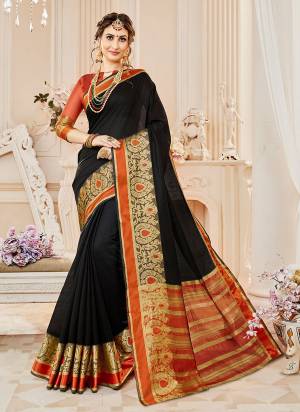 Have A Bold And Beautiful Look Wearing This Saree In Black Color Paired With Rust Orange Colored Blouse. This Saree And Blouse Are Fabricated On Cotton Silk Beautified With Weave Over The Border. Buy This Saree Now.