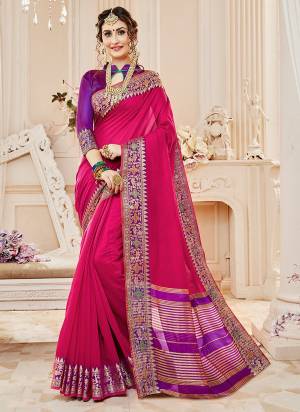 Enhance Your Personality Wearing This Saree In Dark Pink Color Paired With Contrasting Purple Colored Blouse. This Saree And Blouse Are Fabricated On Cotton Silk Beautified With Weave All Over. Buy This Saree Now.