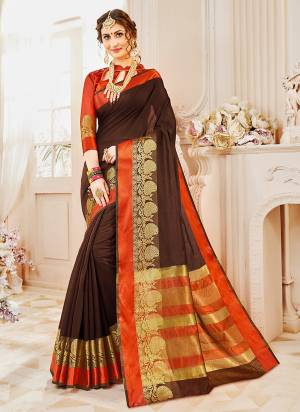 For An Attractive Royal Look, Grab This Designer Saree In Brown Color Paired With Contrasting Orange Colored Blouse. This Saree And Blouse Are Fabricated On Cotton Silk Which Will Give A Rich Look To Your Personality.