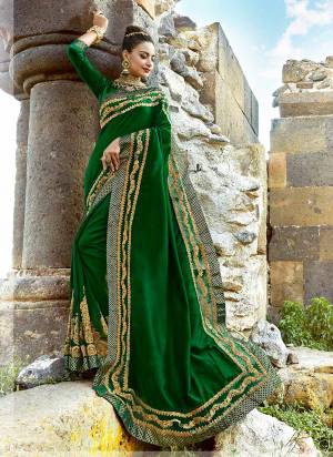 Here Is A Beautiful Saree In Dark Green Color Paired With Dark Green Colored Blouse. This Saree Is Fabricated On Silk Paired With Art Silk Fabricated Blouse. This Designer Saree IS Beautified With Attractive Embroidery. 