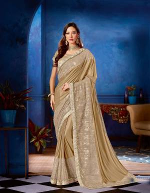 Re-imagine festive dressing in this modern day , dreamy saree in subtle shade of gold adorned with just the right amount of festive sparkle. Pair it with statement diamond jewels for a perfect look. 