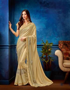Embrace a fine romance of the classic Indian saree in a modern day appeal in this beige hued number. Add multi-layered earrings to look stunning. 