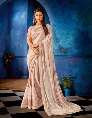 Opt for this dusty blush pink saree with tonal details this festive season and look like a delicate diva. 