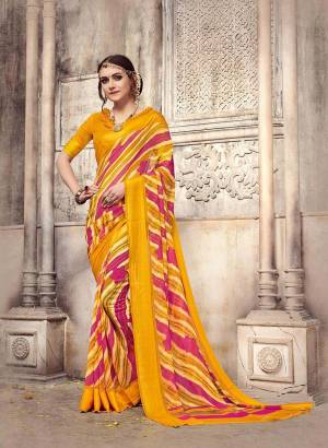 Look Beautiful And Attractive Wearing This Saree In Yellow And Pink Color Paired With Yellow Colored Blouse. This Saree And Blouse are Fabricated On Georgette Beautified With Lining Prints All Over. 