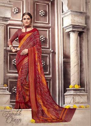 Here Is A Simple But Rich Looking Saree In Maroon Color Paired With Maroon Colored Blouse. This Saree And Blouse Are Fabricated On Georgette Beautified With Bandhani Prints. Also It Is Light Weight And Easy To Carry All Day Long.
