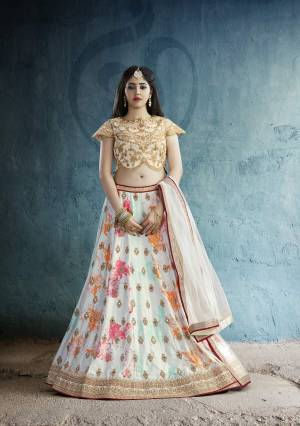 Simple And Elegant Looking Designer Lehenga Choli Is Here In Beige Colored Blouse Paired With Off-White Colored Lehenga And Dupatta. Its Blouse Is Fabricated On Art Silk Paired With Crepe Lehenga And Net Dupatta. It Is Beautified With Prints And Embroidery. Buy This Lehenga Choli Now.
