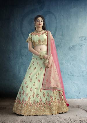 This Season Is About Subtle Shades And Pastel Play, Grab This Designer Lehenga Choli In Pastel Green Color Paired With Contrasting Pink Colored Dupatta. Its Blouse And Lehenga Are Art Silk Based Fabric Paired With Net Dupatta. It Has Very Pretty Contrasting Embroidery Over The Lehenga And Blouse. 