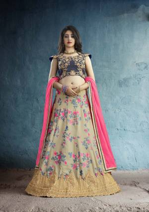 New And Unique Designer Lehenga Choli Is Here In Navy Blue Colored Blouse Paired With Beige Colored Lehenga And Fuschia Pink Colored Dupatta. Its Blouse Is Fabricated On Art Silk Paired With Muslin Silk Lehenga And Chiffon Dupatta. It Has Very Pretty Floral Prints Over The Lehenga Paired With Embroidered Blouse.