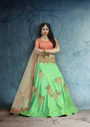 Here Is An Attractive Traditional Combination With This Designer Lehenga Choli In Orange Colored Blouse, paired With Green Colored Lehenga And Beige Colored Dupatta. This Lehenga Choli Is Fabricated On Art Silk Paired With Net Fabricated Dupatta. Buy Now.