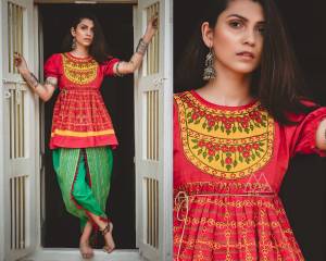 Grab This Trendy Looking Designer Kedia Set For Women In Red Colored Top Paired With Contrasting Green Colored Dhoti Bottom. This Top And Bottom Are Fabricated On Khadi Beautified With Thread Work And Lace Border.