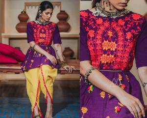 Add This Beauty To Your Wardrobe With This Designer Pair Of Kedias For This Festive Season. Its Top Is In Purple Color Paired With Contrasting Yellow Colored Dupatta. Its Top And Bottom Are Fabricated On Khadi Beautified With Thread Work And Lace Border.
