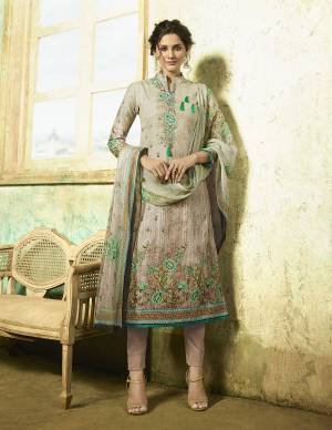 Flaunt Your Rich And elegant Taste Wearing This Designer Suit In Grey And Beige Colored Top Paired With Beige Colored Bottom And Grey And Beige Dupatta. Its Top And Bottom Are Fabricated On Cambric Cotton Paired With Chiffon Dupatta. Buy This Semi-Stitched Suit Now.
