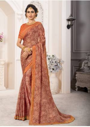 Grab This Pretty Looking Saree In Light Brown Color Paired With Orange Colored Blouse. This Saree Is Fabricated On Georgette Chiffon Paired With Art Silk Fabricated Blouse. It Is Beautified with Prints And Stone Work. Buy Now.