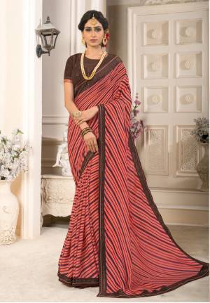 Look Pretty Wearing This Saree In Pink Color Paired With Contrasting Brown Colored Blouse. This Saree Is Fabricated On Georgette Chiffon Paired With Art Silk Fabricated Blouse. It Is Beautified With Prints And Stone Work. Buy This Saree Now.