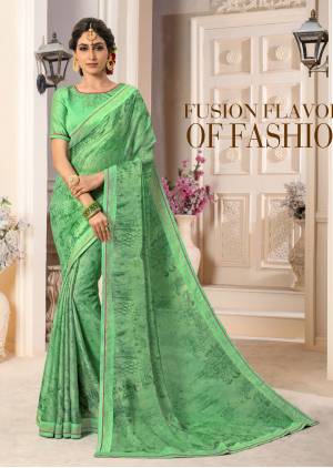 Celebrate This Festive Season Wearing This Light Green Colored Saree Paired With Light Green Colored Blouse. This Saree Is Fabricated On Georgette Chiffon Paired With Art Silk Fabricated Blouse. It Has Stone Work Over The Blouse And Saree Lace Border.